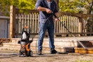 man using pressure washer on stairs