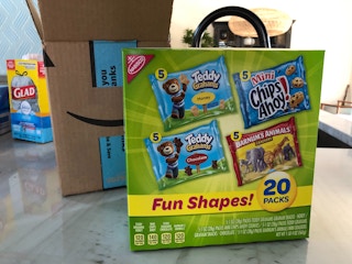 A Nabisco snack pack in front of an open delivery box.