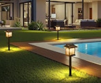 solar pathway lights in a backyard next to a pool