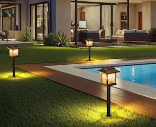 solar pathway lights in a backyard next to a pool