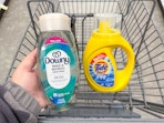 hand holding downy rinse and tide simply item in cart