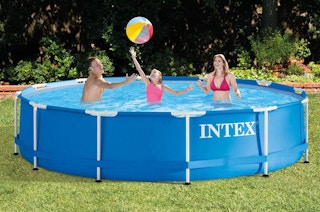 a family in a pool in the yard