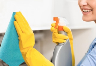 person cleaning with cloth