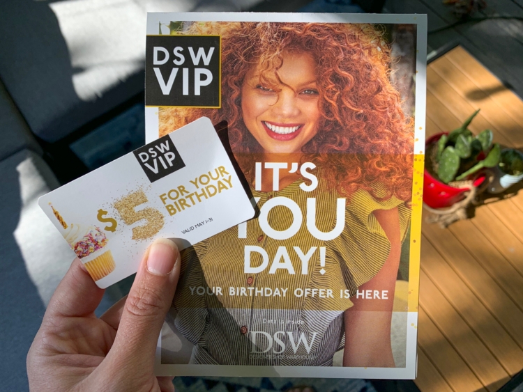 Hand holding DSW VIP $5 birthday offer