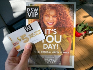 Hand holding DSW VIP $5 birthday offer