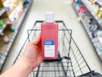 person holding a loreal toner over a cart