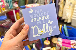 hand holding dolly parton tabletop sign