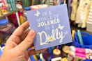hand holding dolly parton tabletop sign