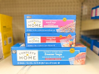 three boxes of Complete Home Storage bags on shelf