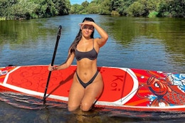 woman sitting on paddle board