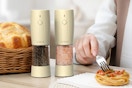 a salt and pepper grinder near spaghetti