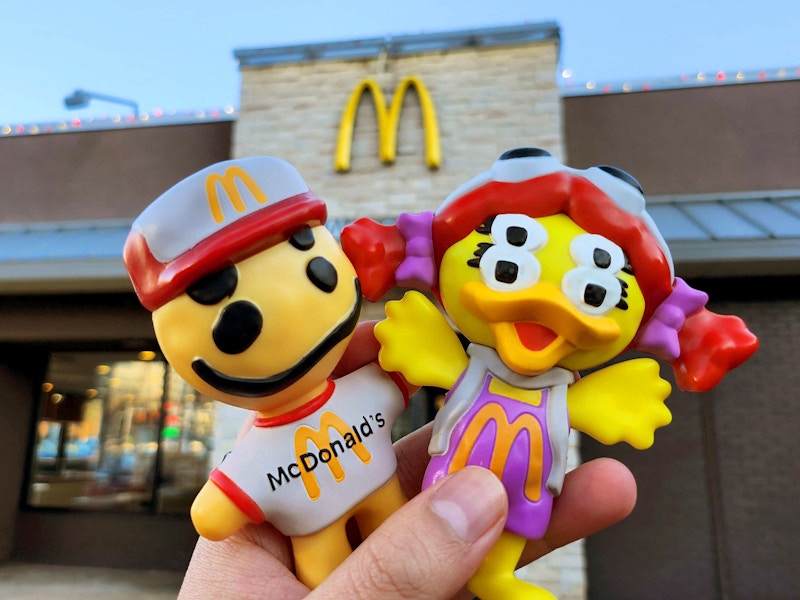 two mcdonalds cactus plant toys set against a mcdonalds background