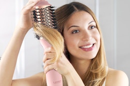 LANDOT Hair Blow Dryer Brush: One-Step Hot Air Brush with 60mm Oval Barrel being used by a woman.