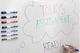 person writing on board with expo marker