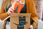 A person taking a Fire TV Stick 4k out of an Amazon box.