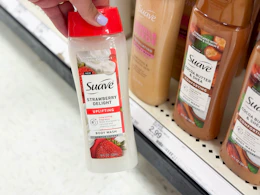 hand holding a suave body wash in front of a target shelf