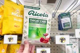 hand touching a bag of ricola cough drops