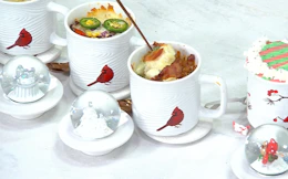 mugs with food inside next to a lid with a snow globe 