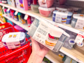 hand holding a bentgo salad container set in front of a target shelf