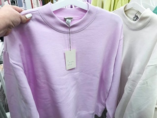 hang holding up women's sweatshirt on hanger