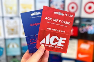 hand holding a Walgreens and ace hardware gift card