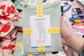 person holding a carter's pajama set