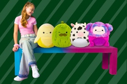 4 Squishmallows (16 inches) on bench next to girl