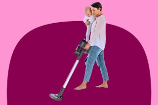 mother holding a baby while vacuuming with the iHome stick vacuum