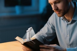 a man using a book light