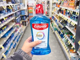 hand holding colgate mouthwash in walgreens