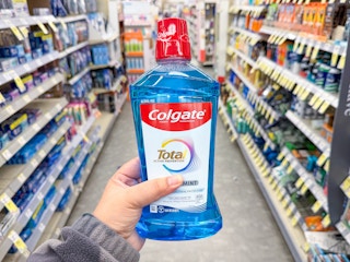 hand holding colgate mouthwash in walgreens