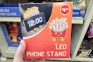 person holding a french fry led phone stand 