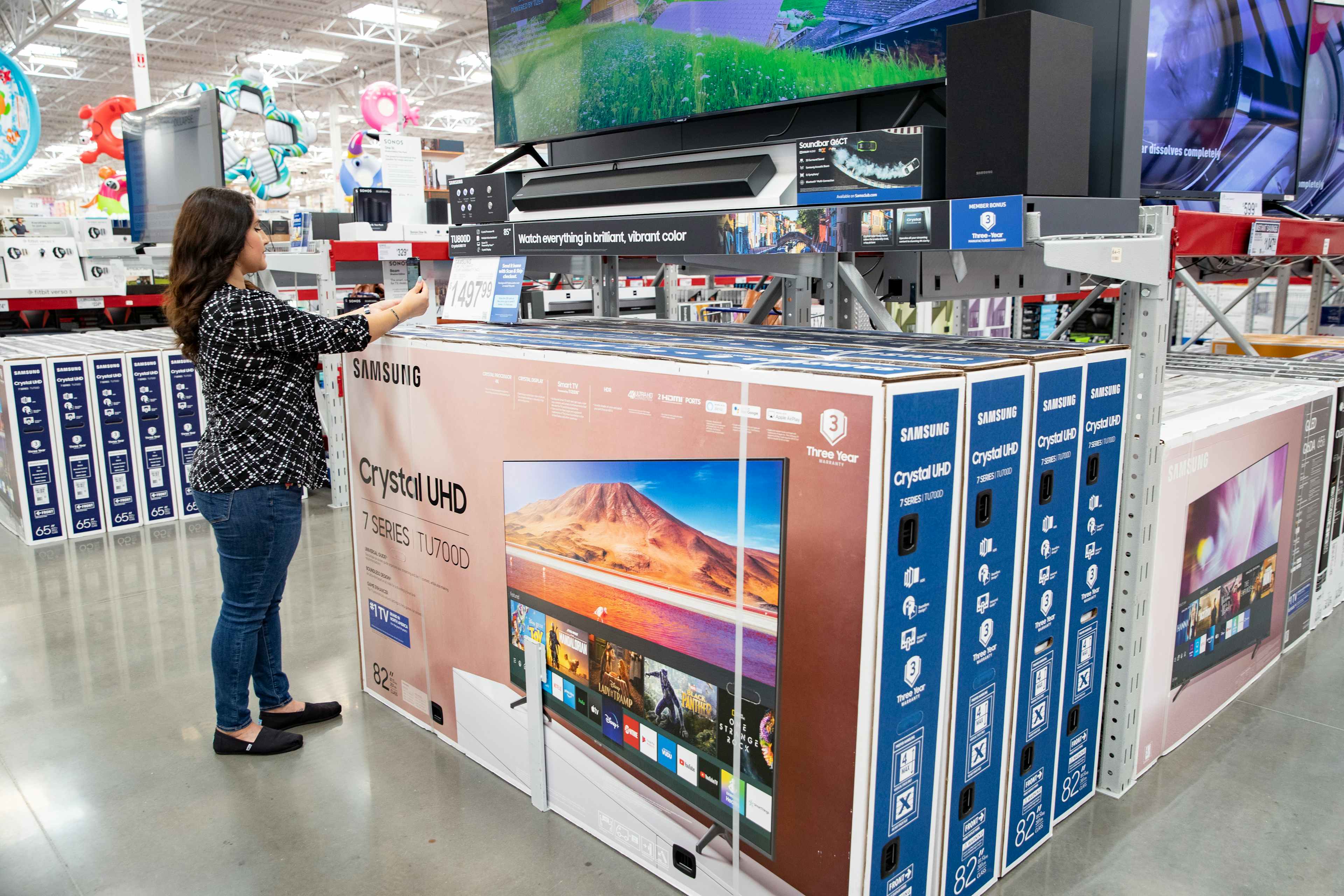 A Sam's Club member shopping for TVs in the electronics section at Sam's Club.
