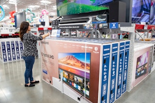 A Sam's Club member shopping for TVs in the electronics section at Sam's Club.
