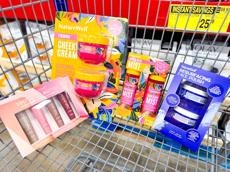 lip butters, body butter, body spray, and face polish in a cart