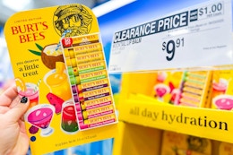 hand holding a pack of burts bees lip balm