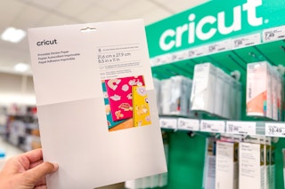 hand holding a pack of cricut printable sticker paper at target