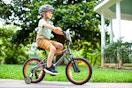 Lifestyle image of child riding a Realtree kids' bike outdoors