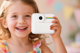 Little girl holding the OTJ Kids Camera Instant Print