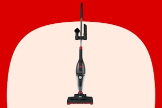 Stock photo of the Dirt Devil 3-in-1 Vacuum over red/cream max shape background