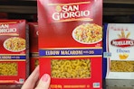 hand holding a box of san giorgio pasta