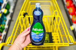 hand holding a bottle of palmolive dish soap at dollar general