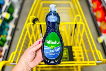 hand holding a bottle of palmolive dish soap at dollar general