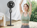 a person stretching in front of a fan