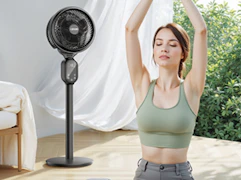 a person stretching in front of a fan