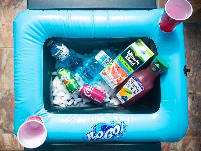 Blue pool raft with assorted drinks with two red cups