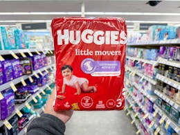 hand holding huggies diaper bag in walgreens