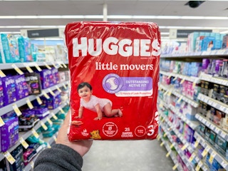 hand holding huggies diaper bag in walgreens