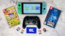 A Nintendo Switch, pro controller, and Best Buy gift card next to some switch video games.