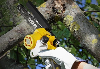 miniature chainsaw used on tree